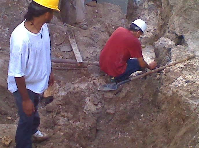 Crew working in an excavation trench at a septic install site